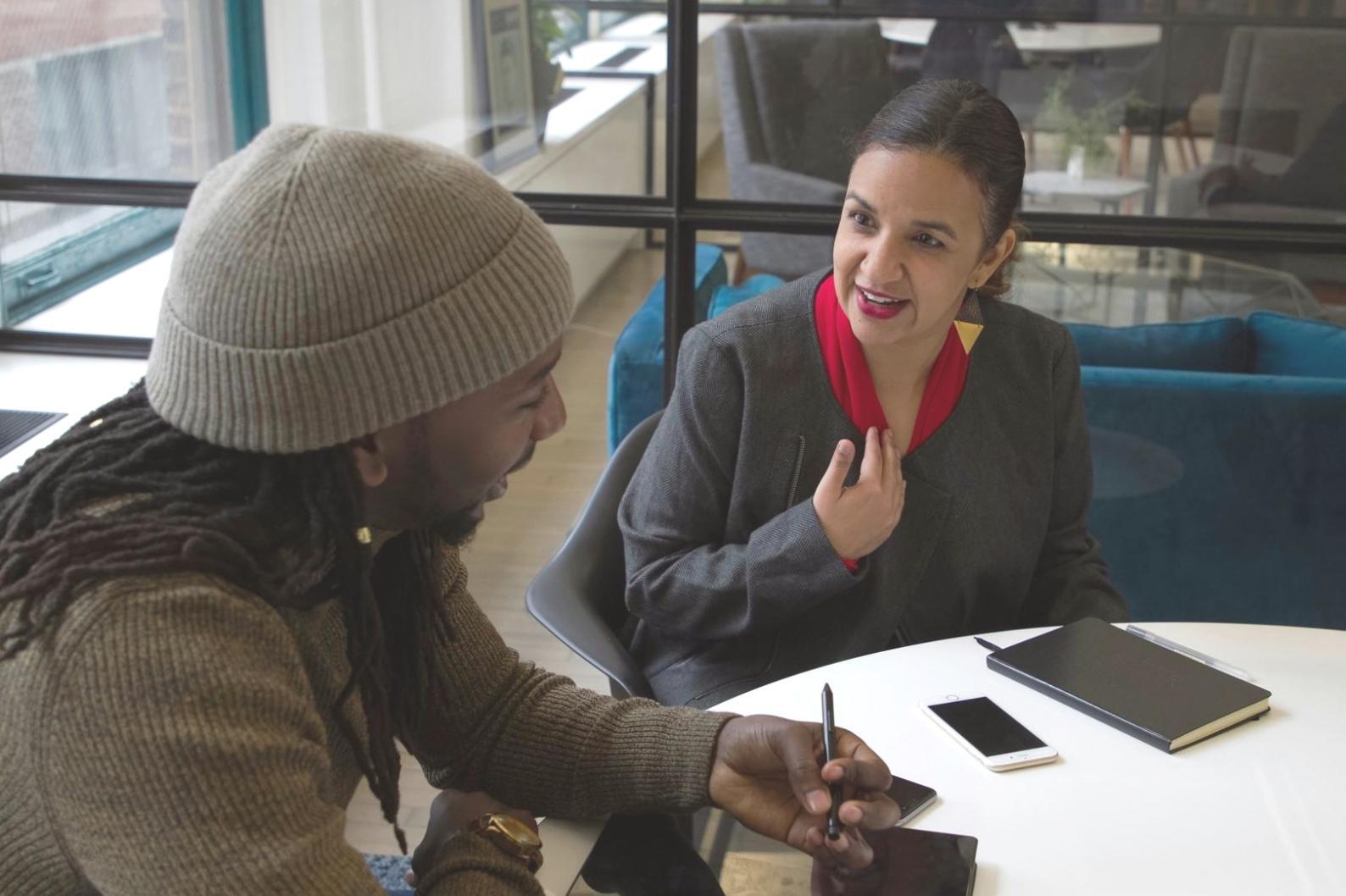 Professional financial planning session showing budget categorization worksheets and planning materials